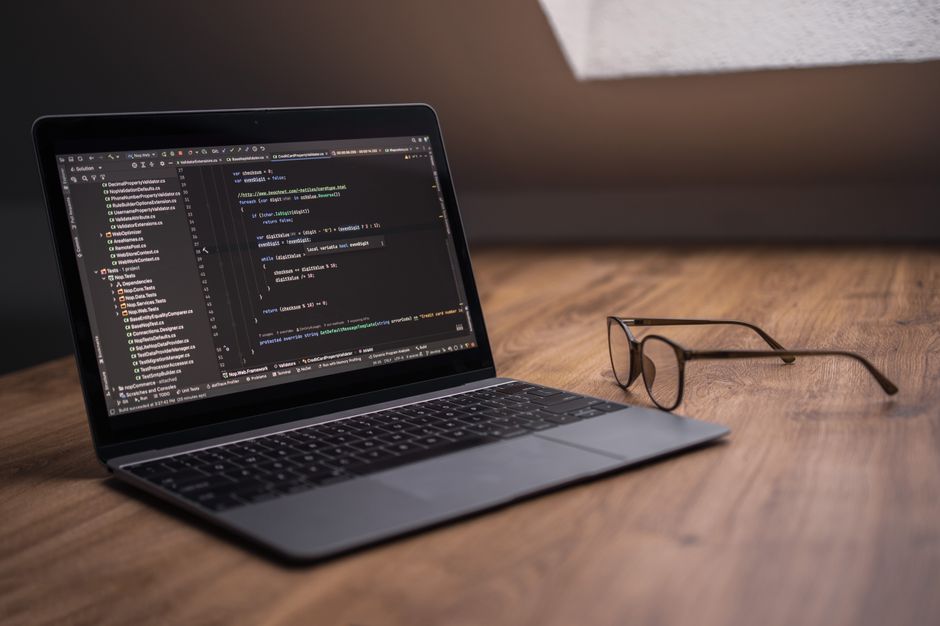 Laptop with code editor and privacy notes on screen
