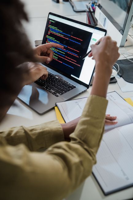 Two students reviewing code together at a desk